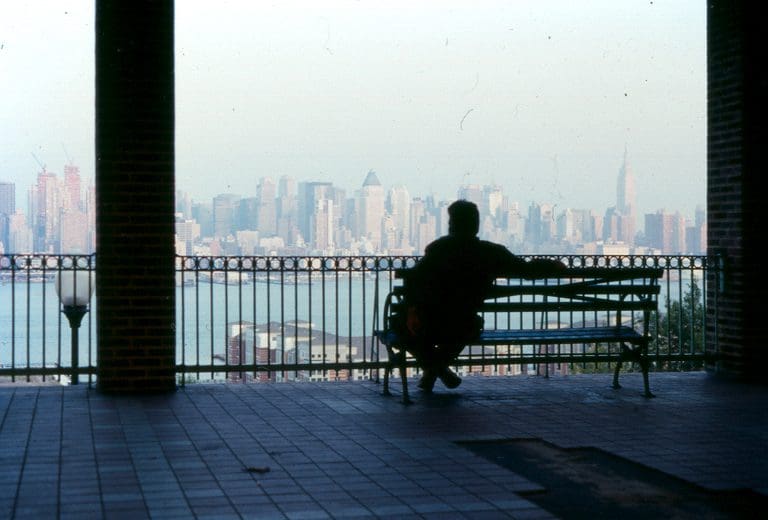 Man sitting on a bench, introspecting his life through compassionate inquiry,