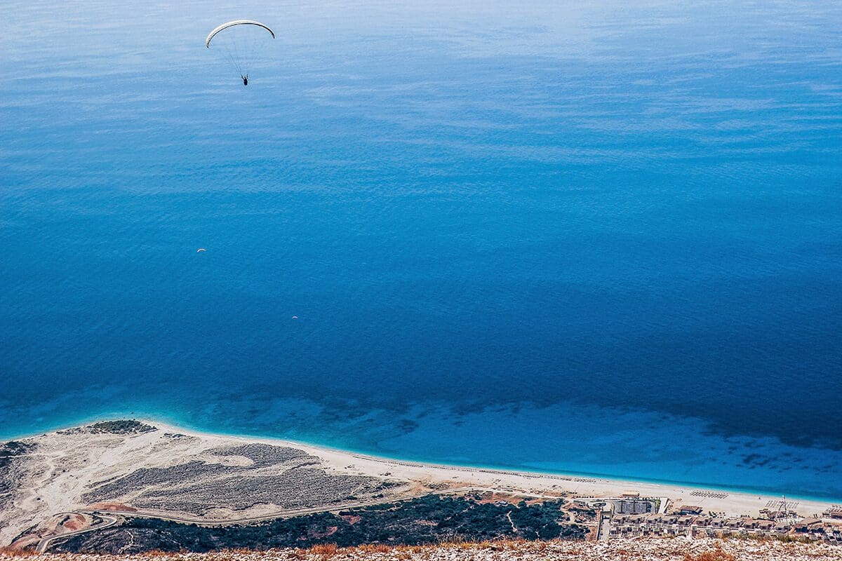 Get Rid of Your Limiting Beliefs in 4 Steps -- a person skydiving over the ocean.