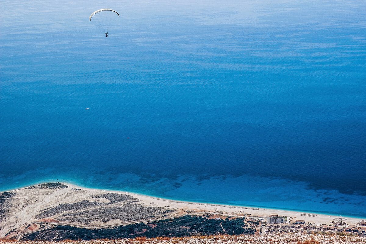 Get rid of your limiting beliefs in 4 steps -- a person skydiving over the ocean.